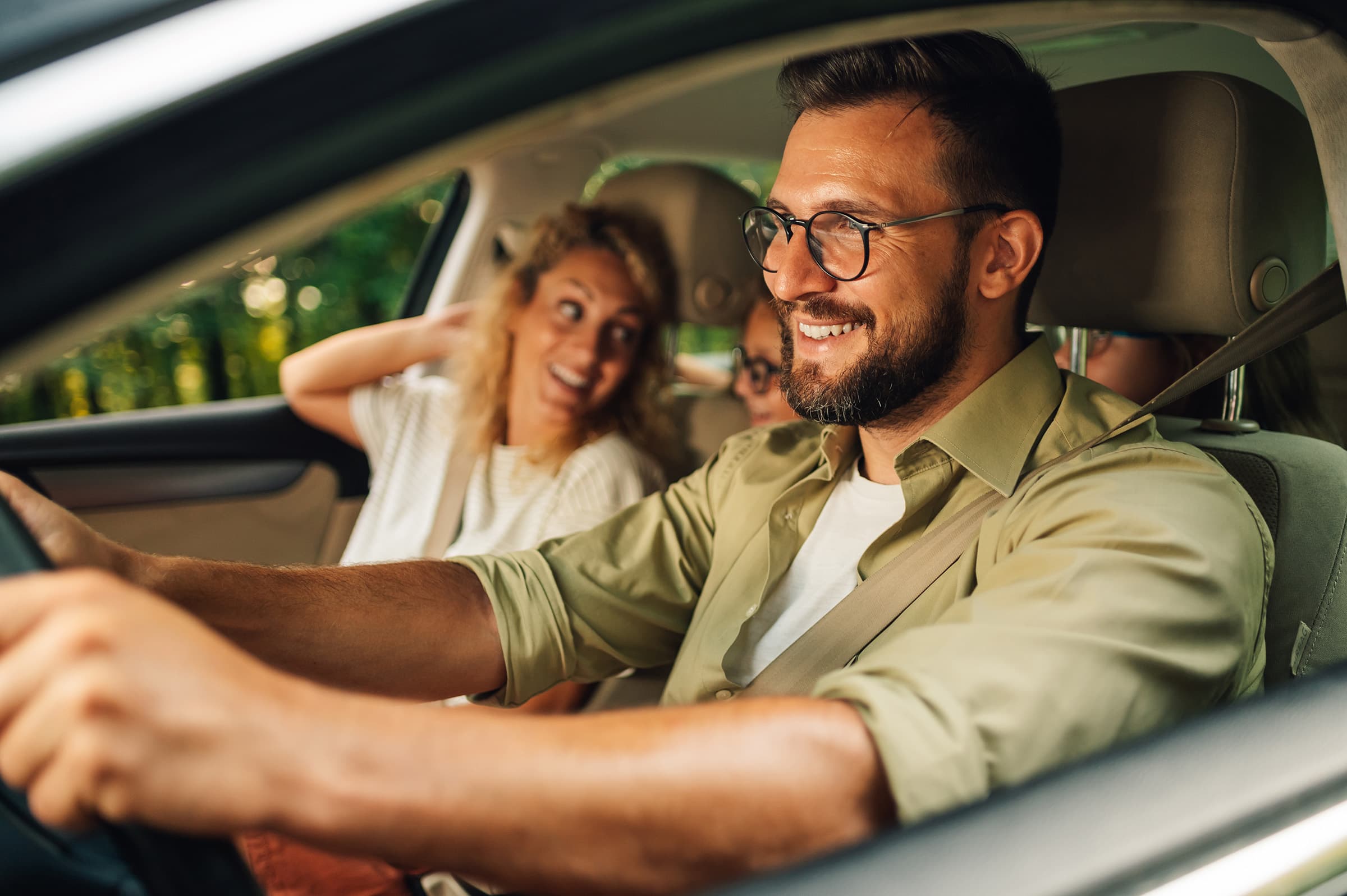 Happy family driving in car