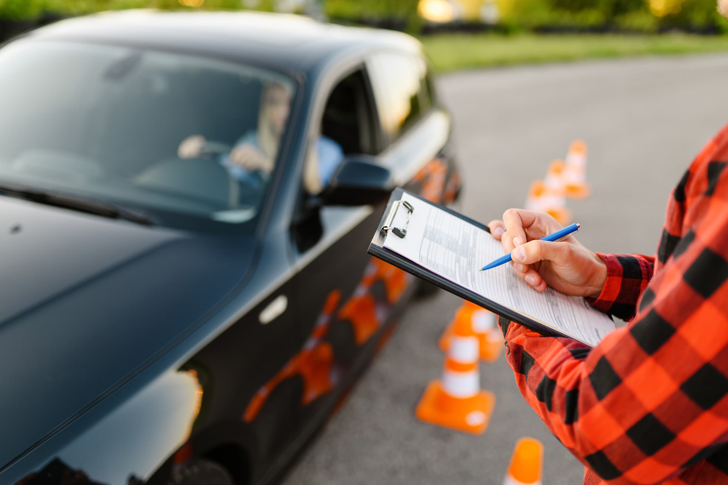 Driving school instructor setting up cones for a demonstration